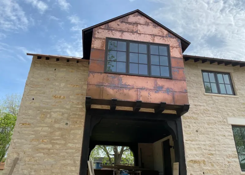 Copper metal panel facade on a stone building for Roof Repair in Lakeland