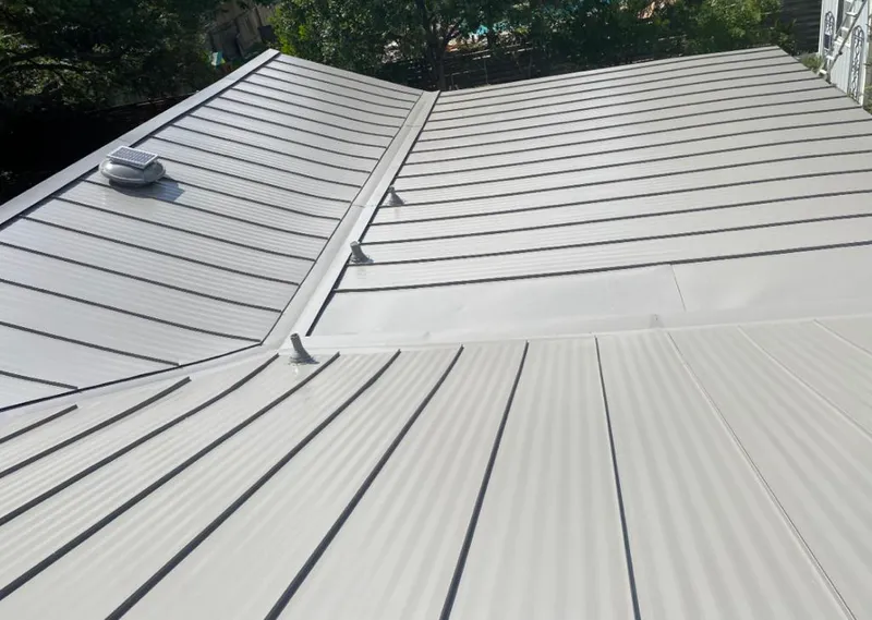 Solar attic fan installed on a metal roof for Roof Ventilation in Lakeland